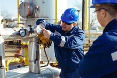 Field technicians operating a process valve